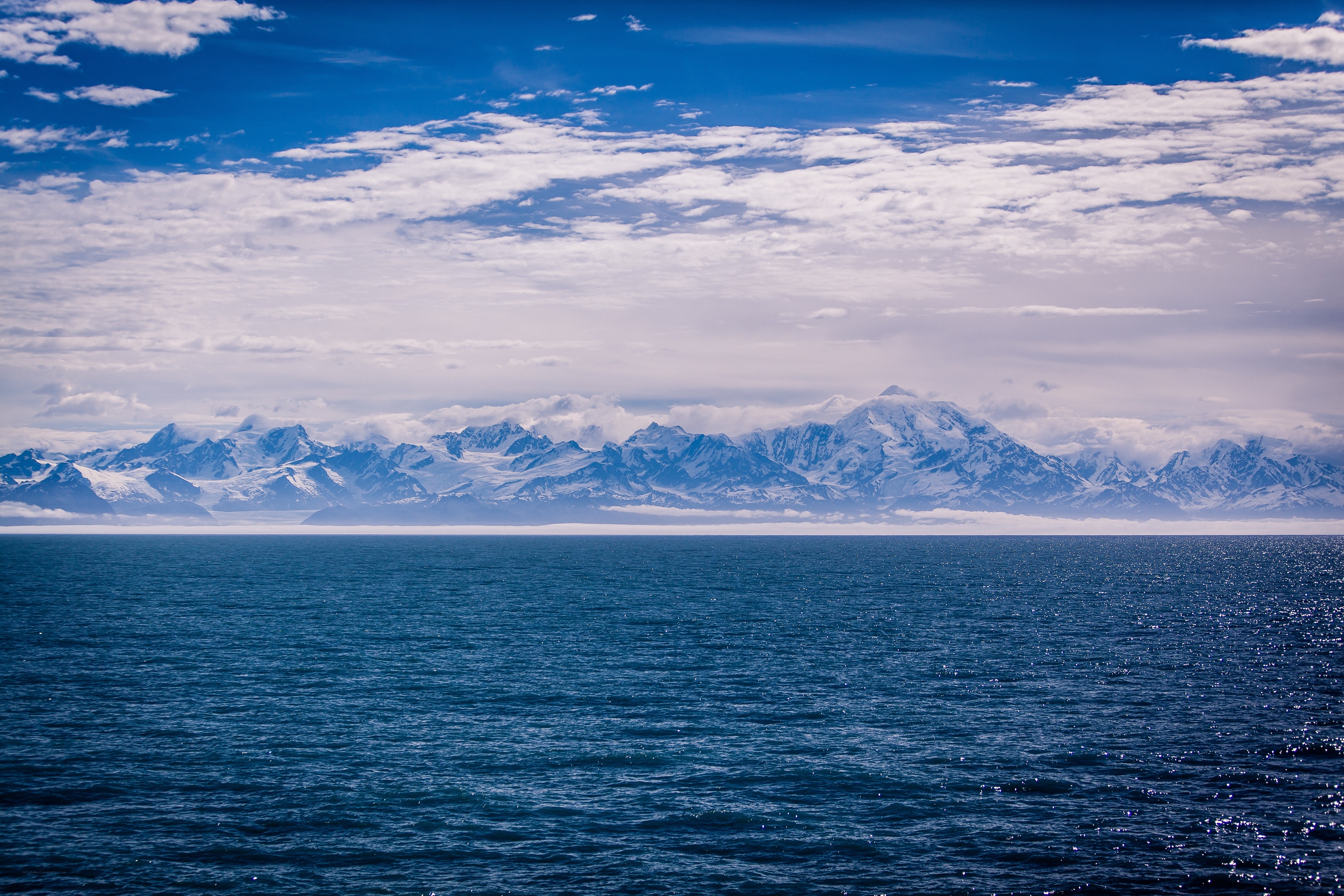 Snow-capped mountains over the sea