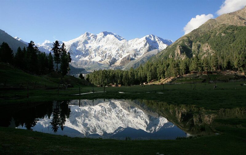 Snow-capped mountains reflect in a lake