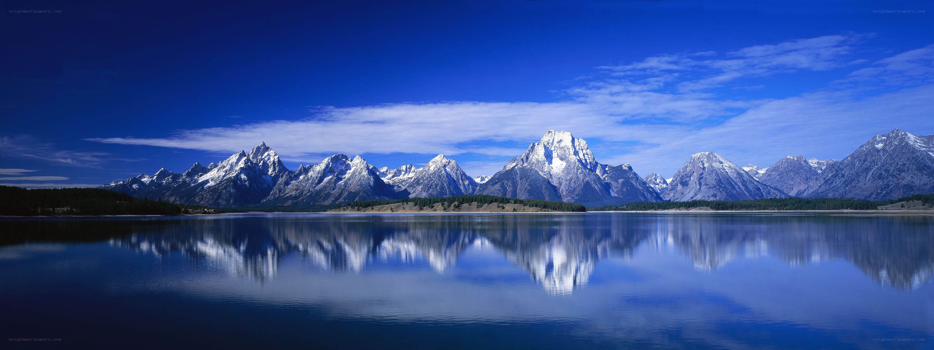Snow-capped mountains reflected in a lake