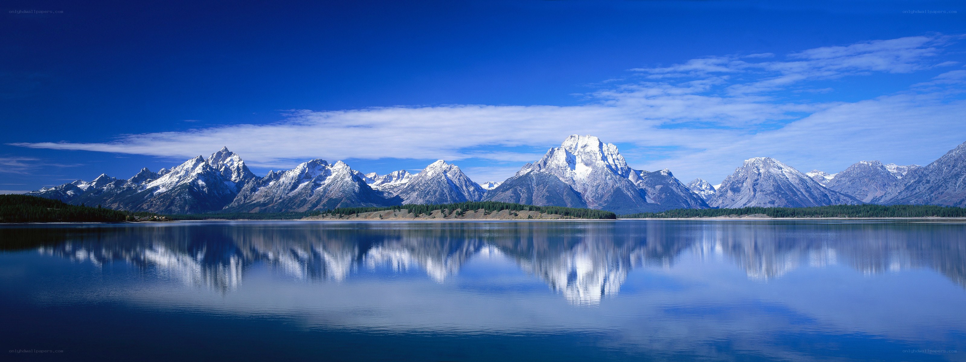Snow-capped mountains reflected in a lake