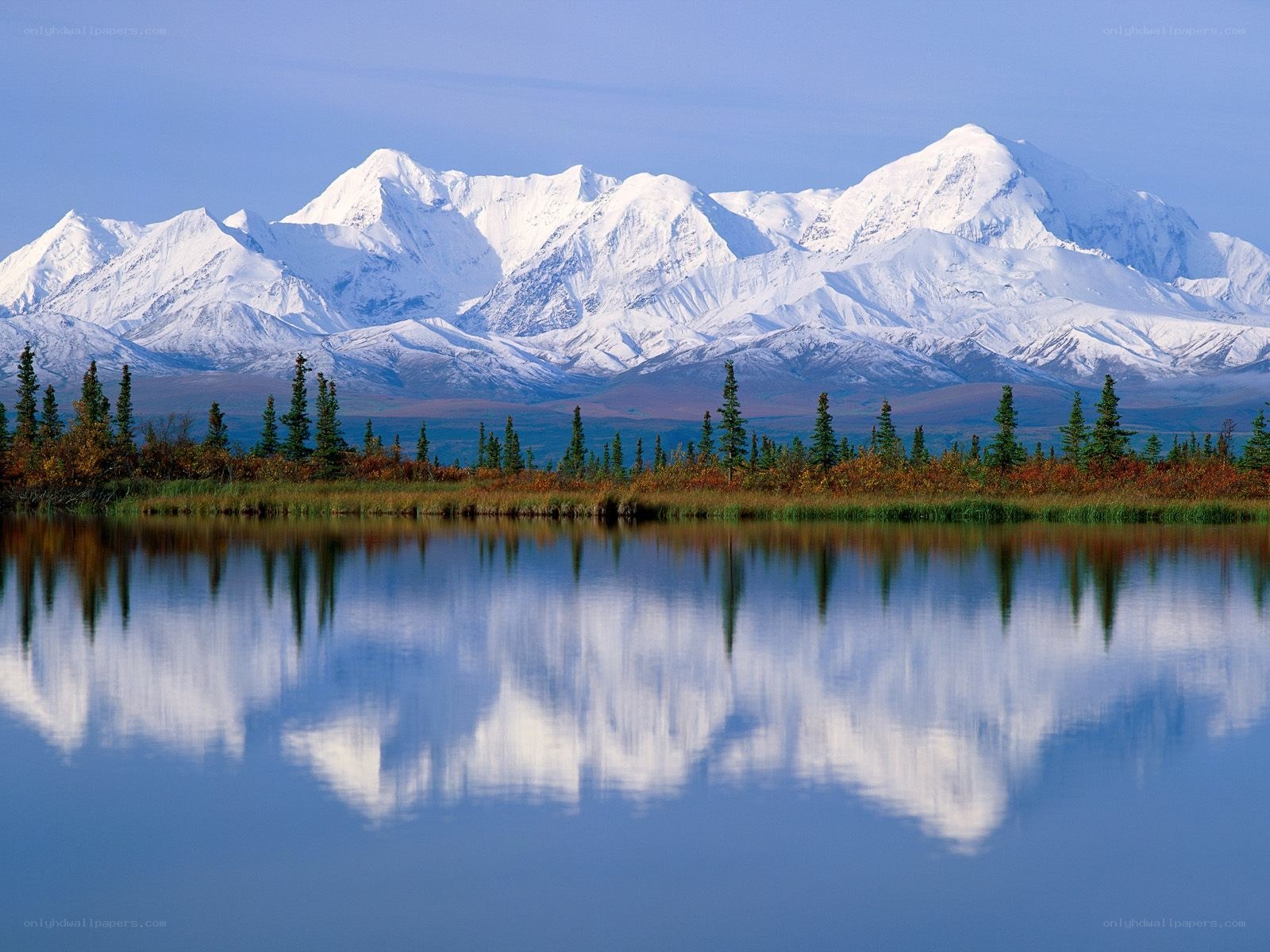 Snow-capped mountains reflected in a lake
