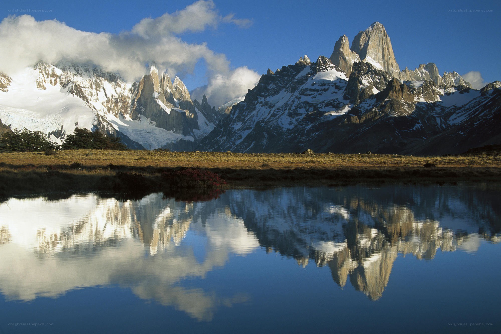 Snow-capped mountains reflected in a lake