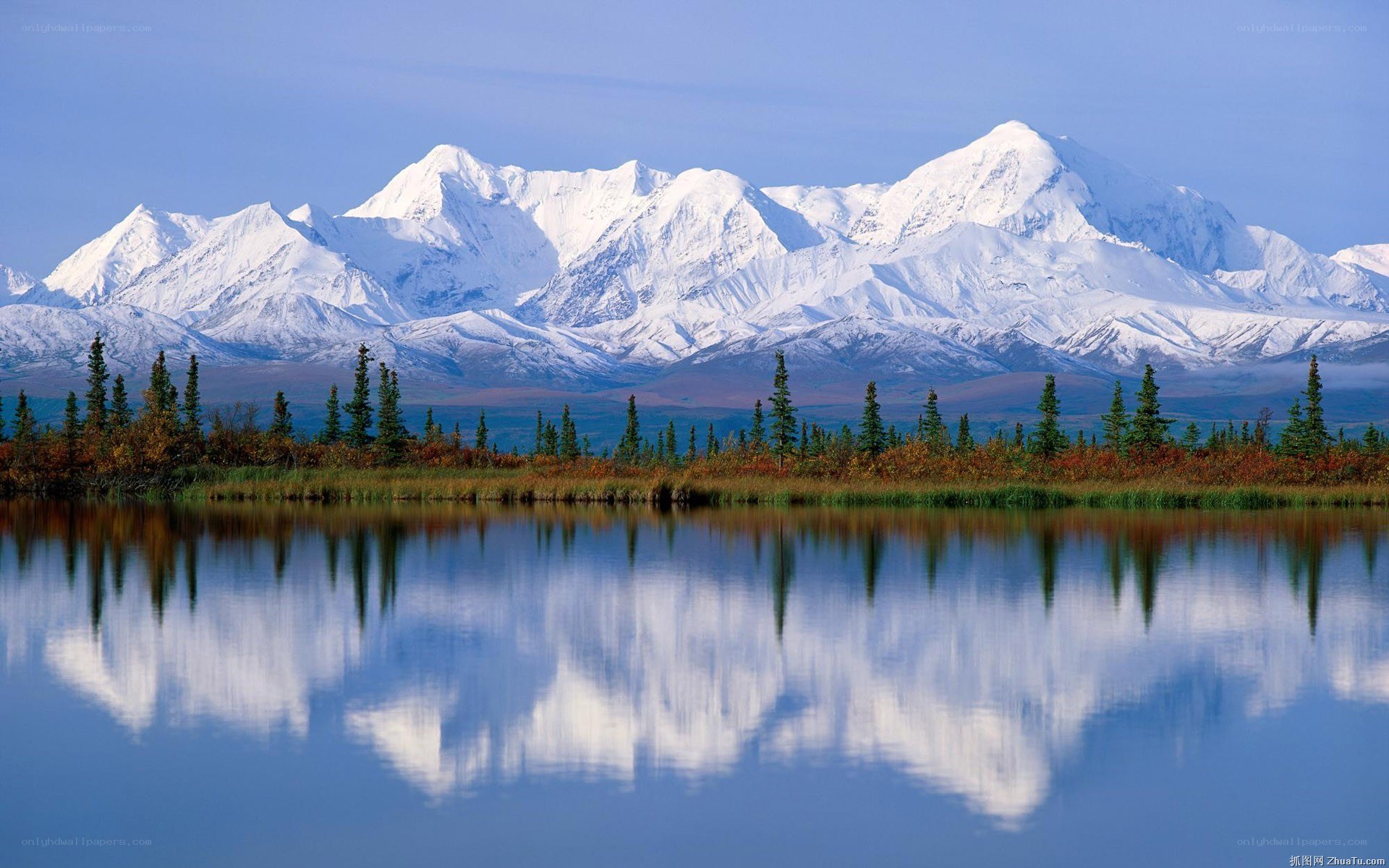 Snow-capped mountains reflected in a lake