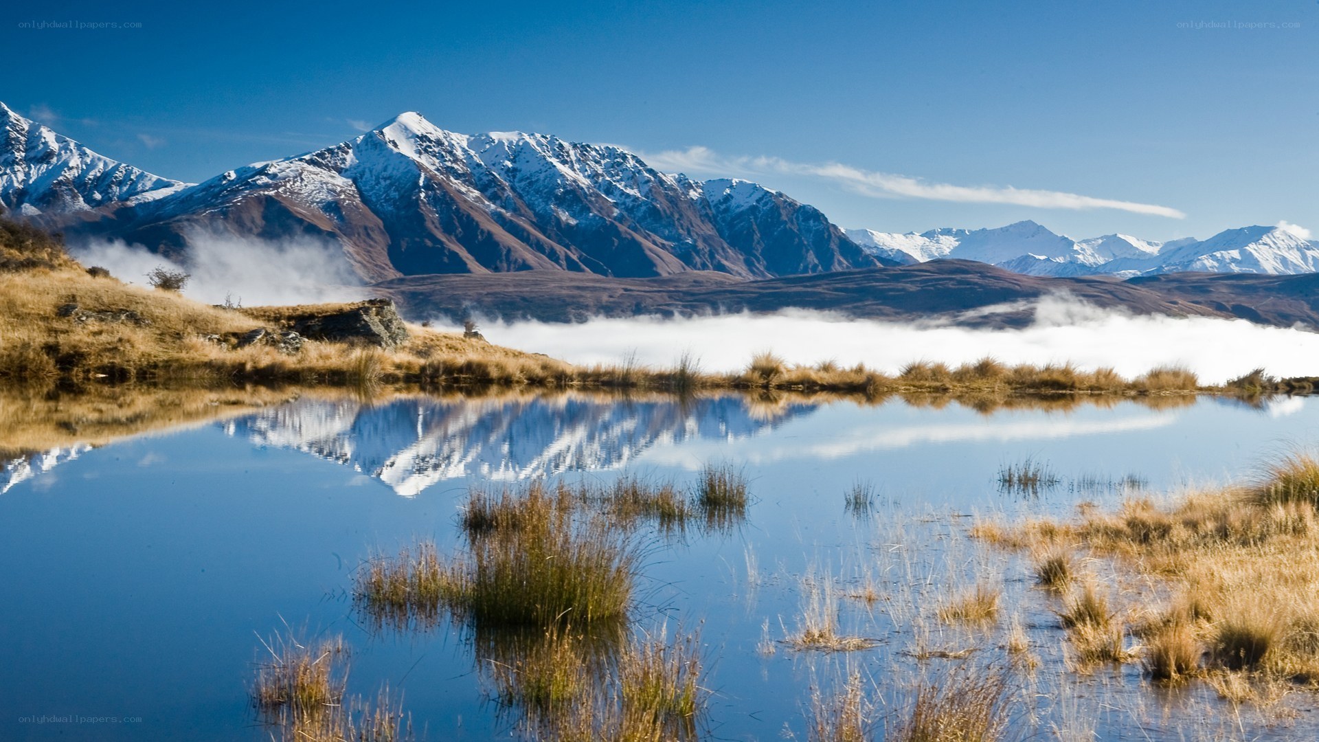 Snow-capped mountains reflected in a lake
