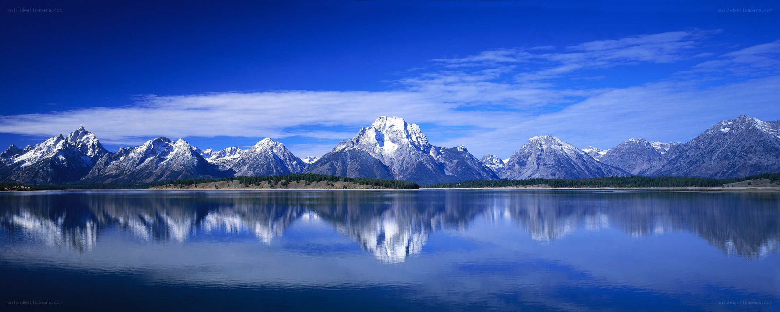 Snow-capped mountains reflected in a lake