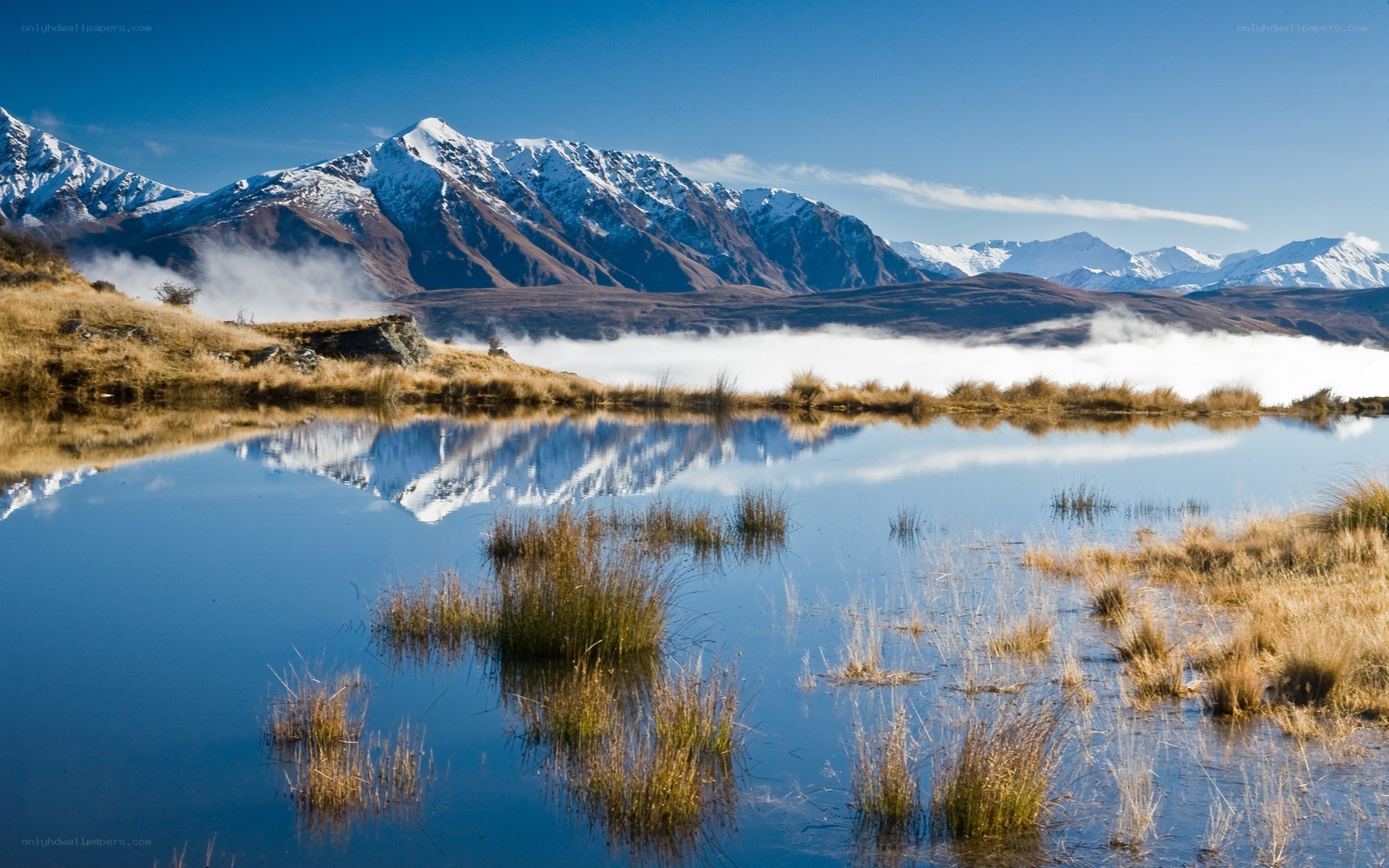 Snow-capped mountains reflected in a lake