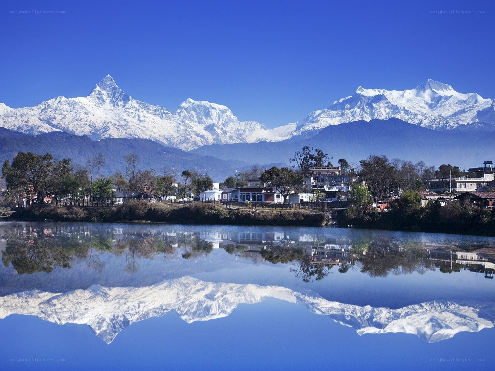 Snow-capped mountains reflected in a lake