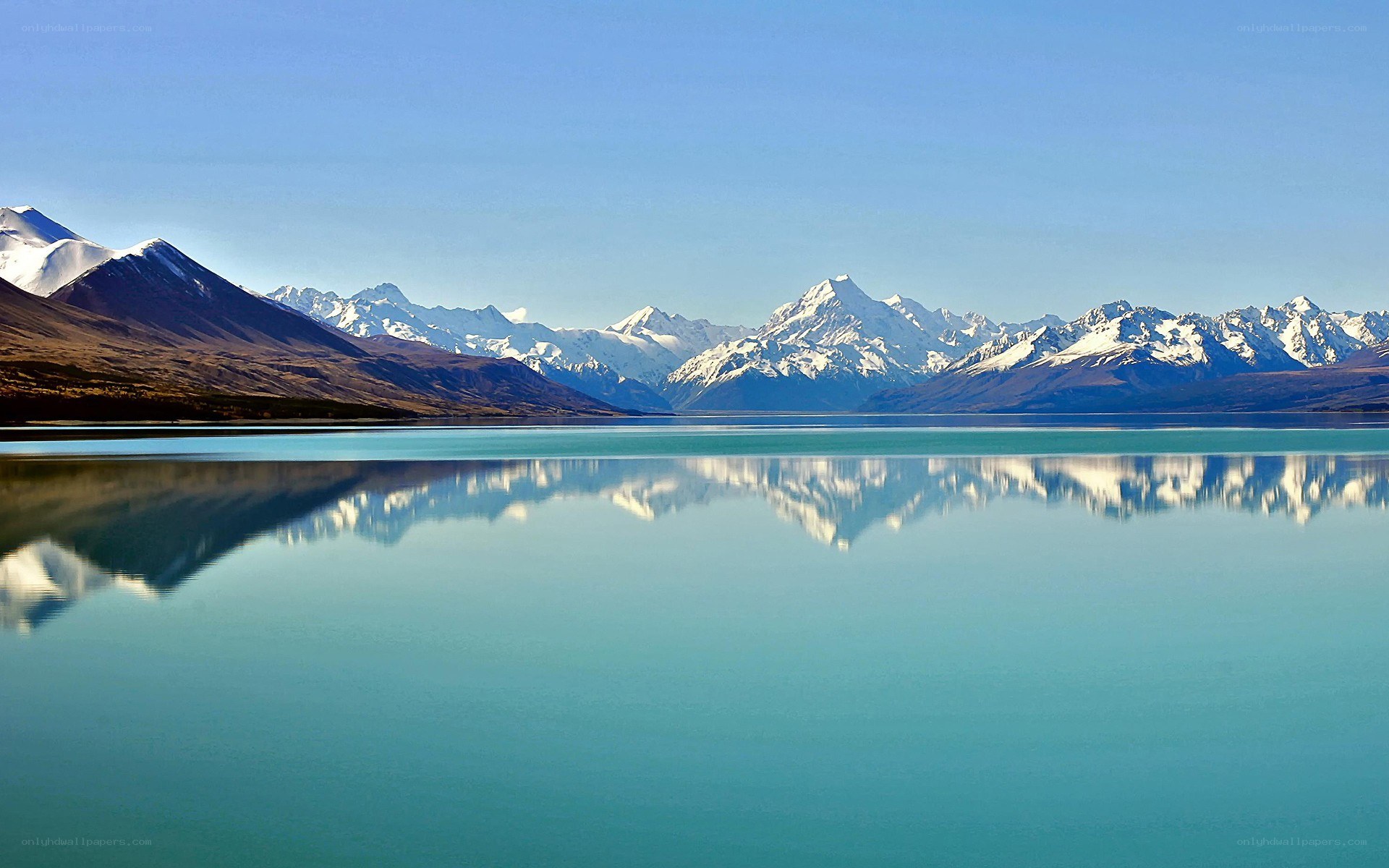 Snow-capped mountains reflected in a lake