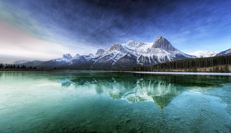Snow-capped mountains reflected in a lake
