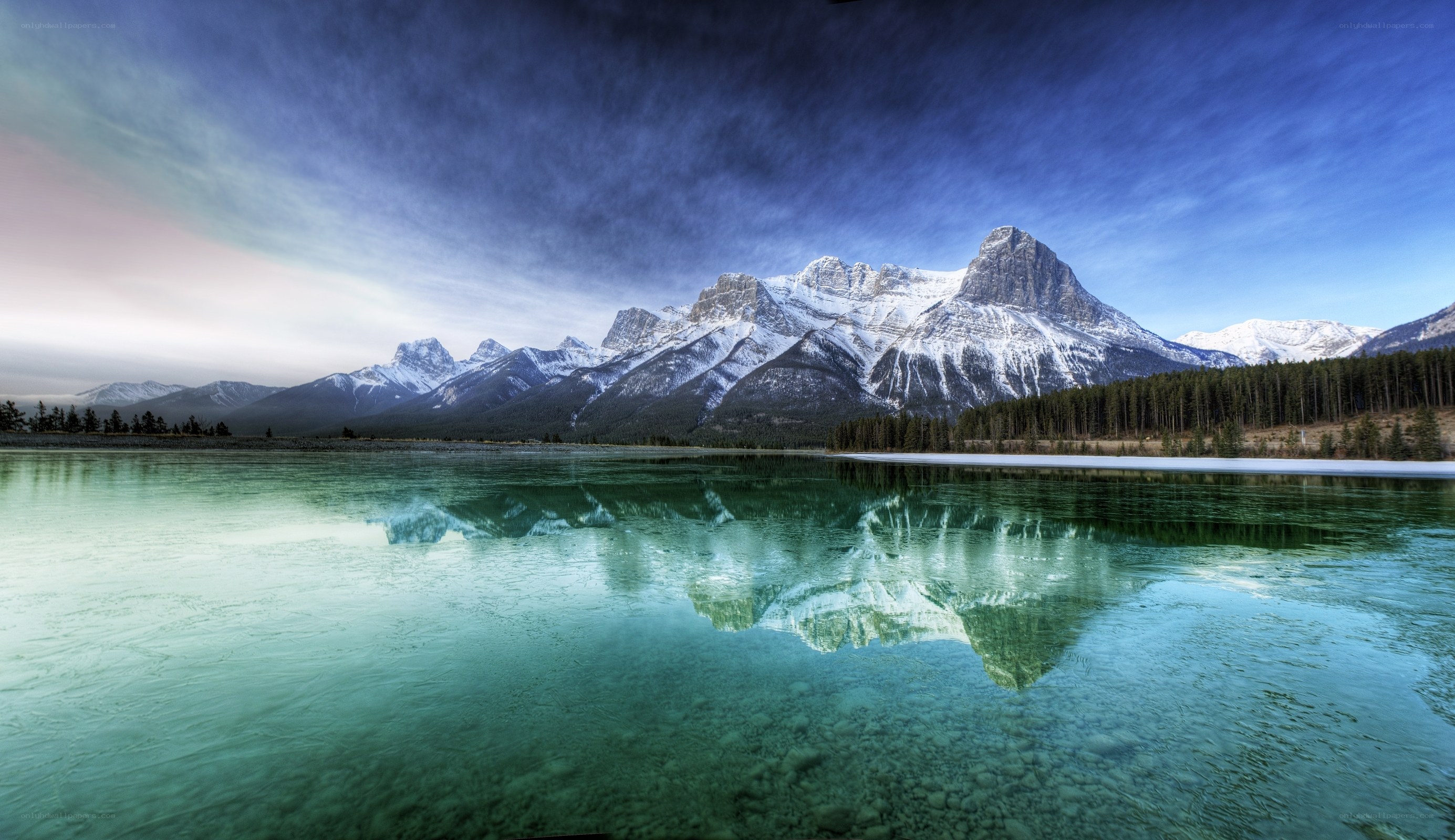 Snow-capped mountains reflected in a lake