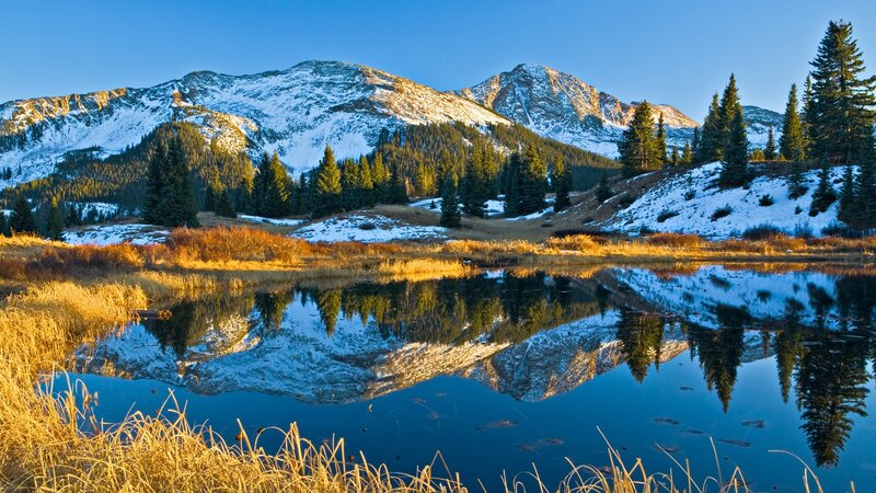 Snow-capped mountains reflected in a lake