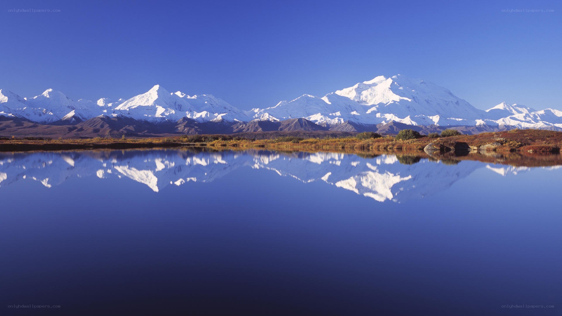 Snow-capped mountains reflected in a lake