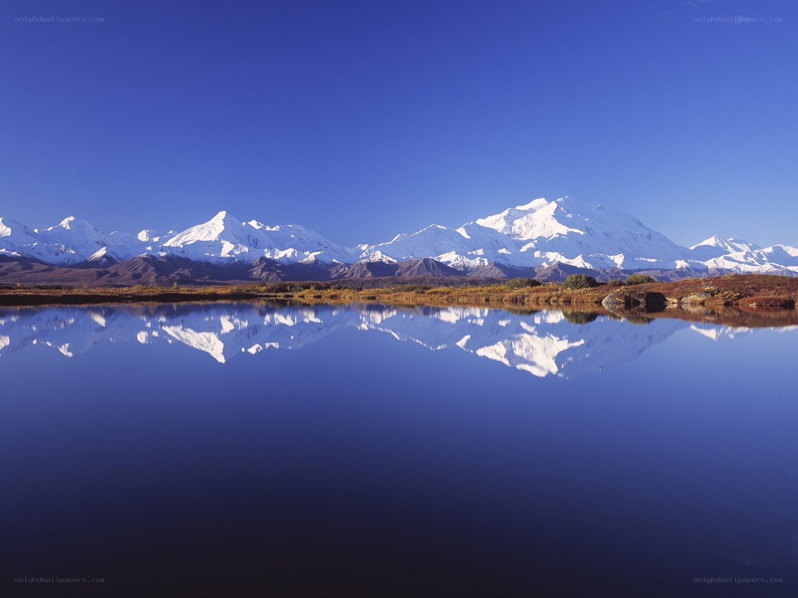 Snow-capped mountains reflected in a lake