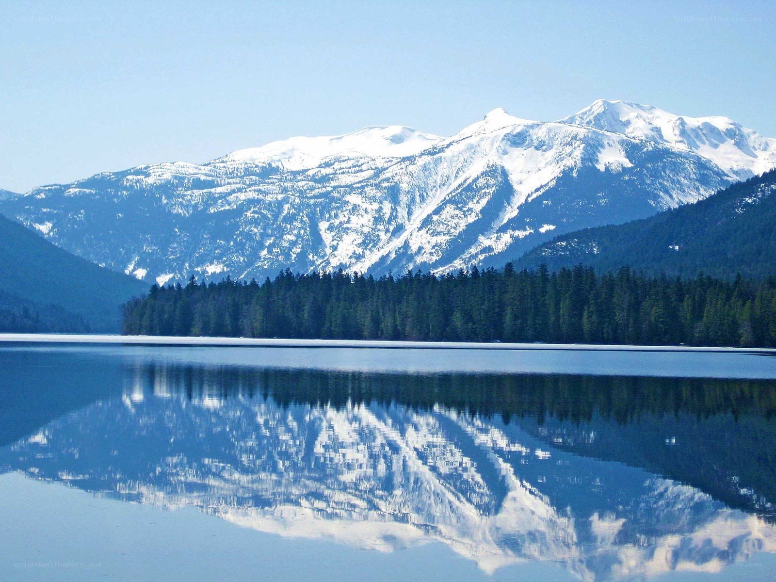 Snow-capped mountains reflected in a lake