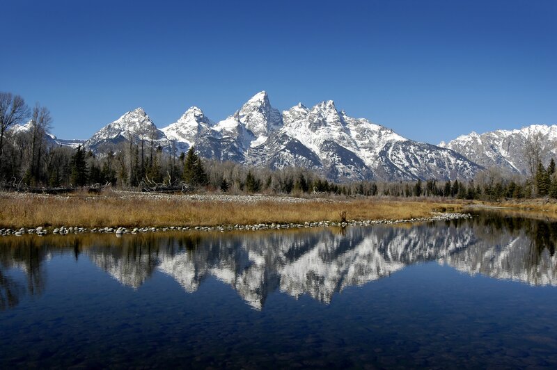 Snow-capped mountains reflected in a lake