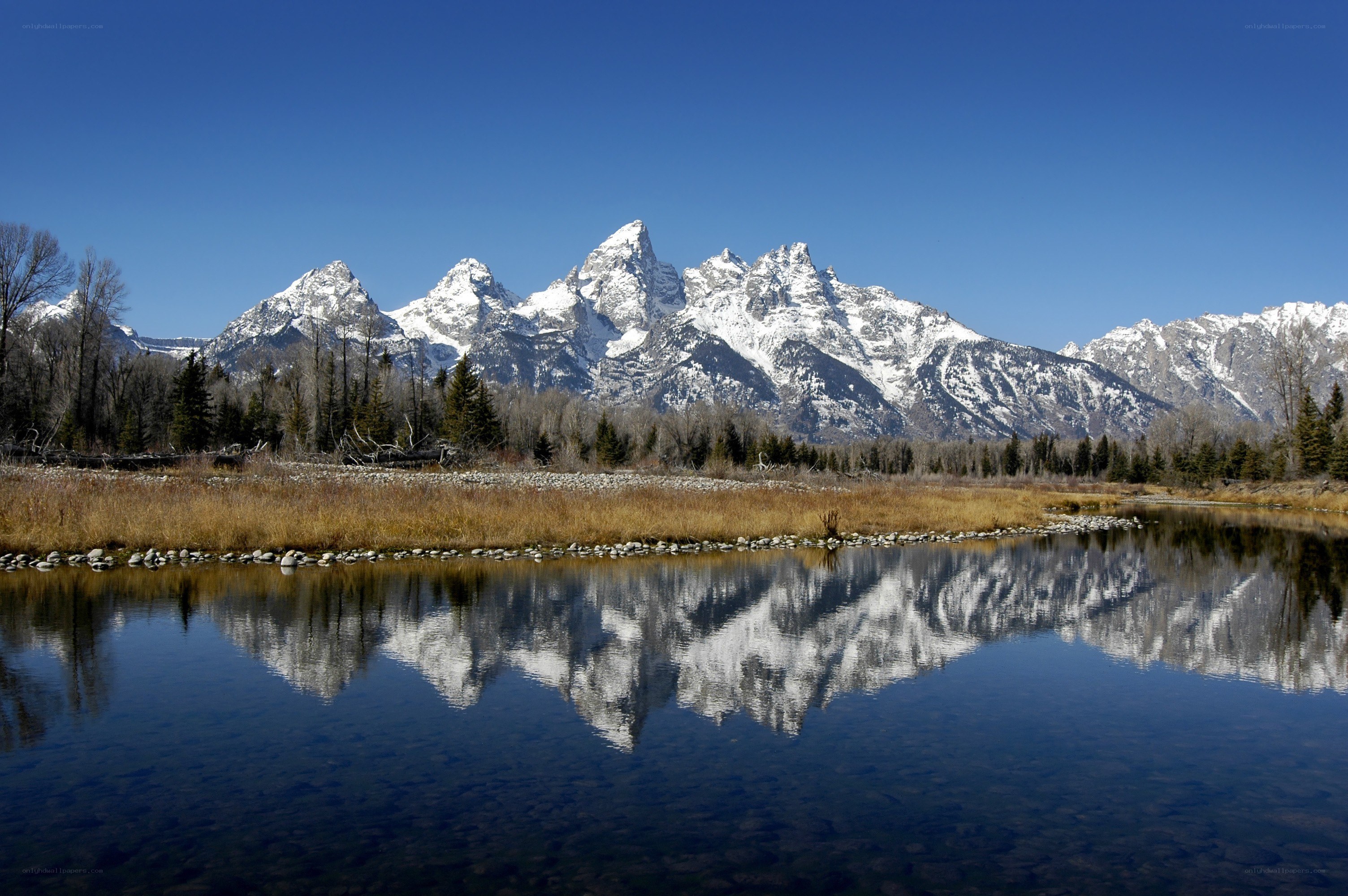 Snow-capped mountains reflected in a lake