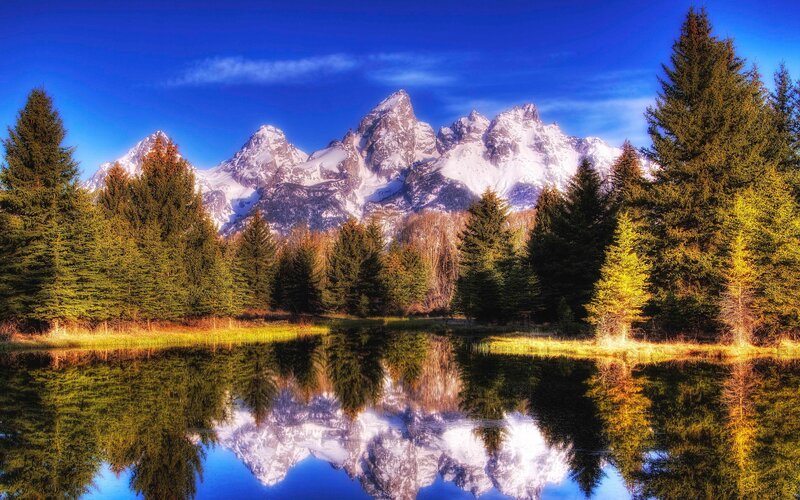 Snow-capped mountains reflected in a lake