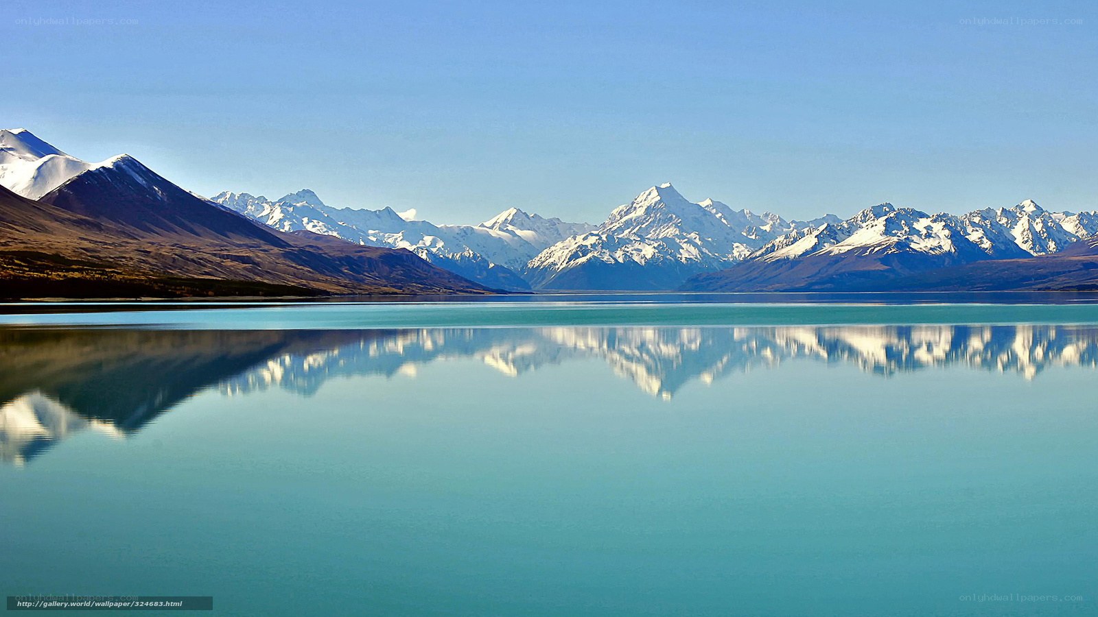 Snow-capped mountains reflected in a lake