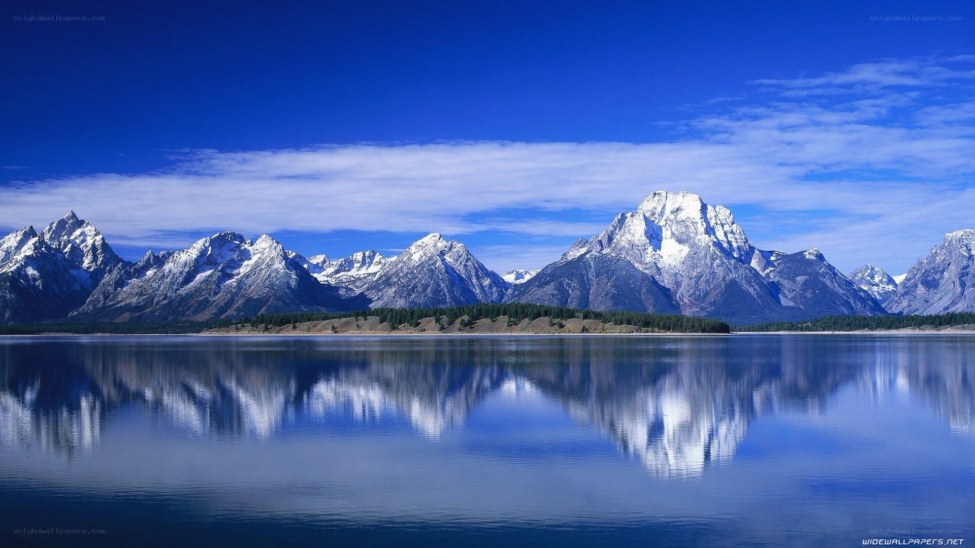 Snow-capped mountains reflected in a lake