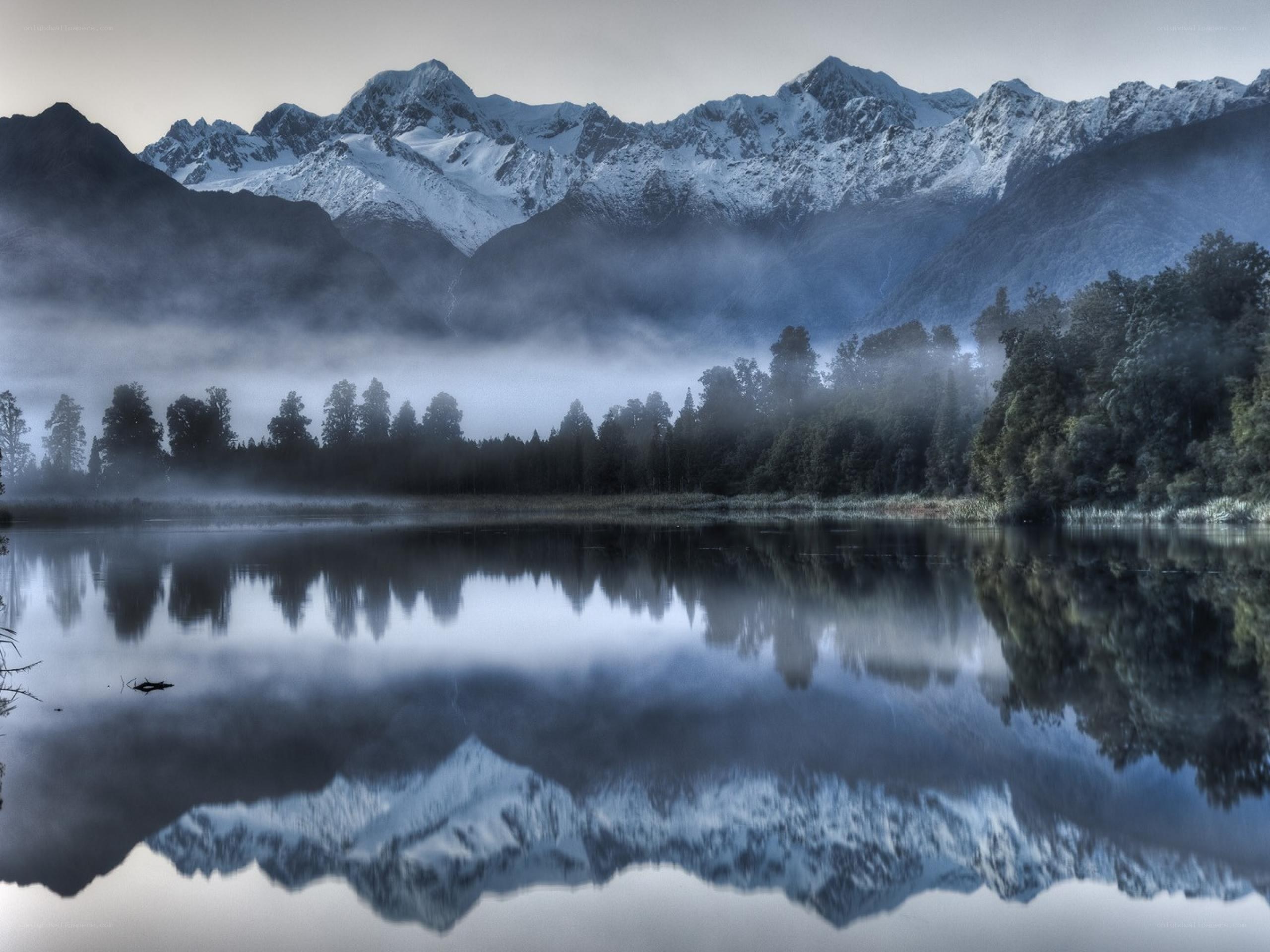 Snow-capped mountains reflected in a lake