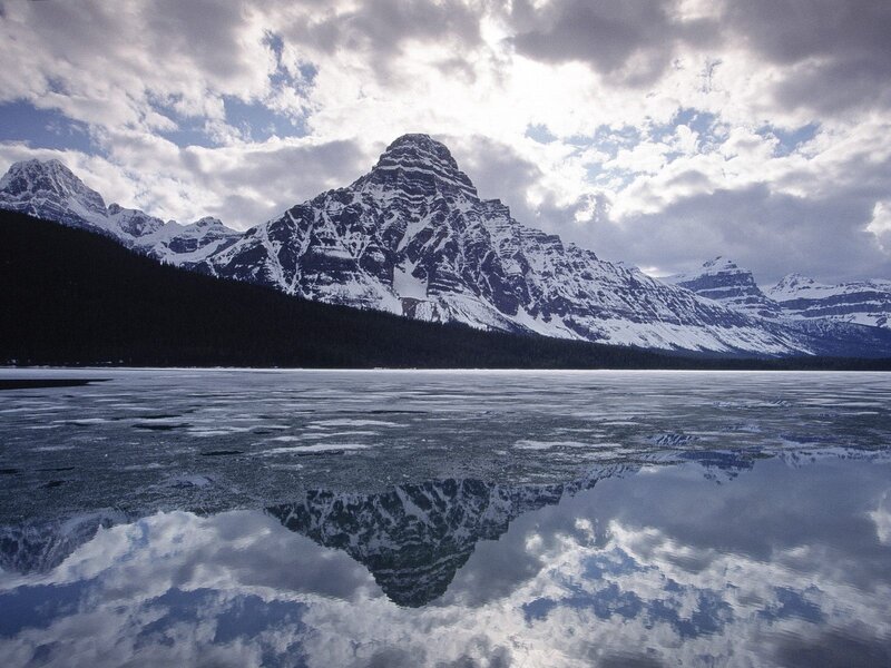 Snow-capped mountains reflected in a lake