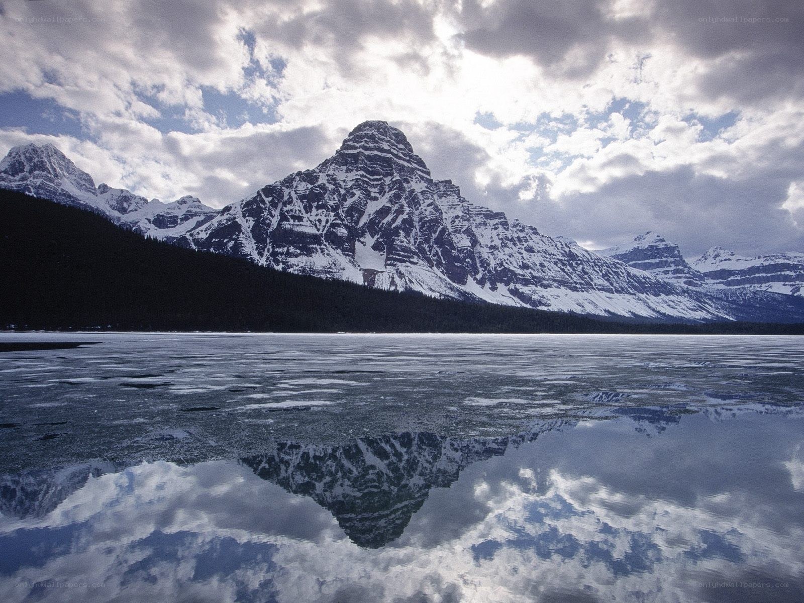 Snow-capped mountains reflected in a lake