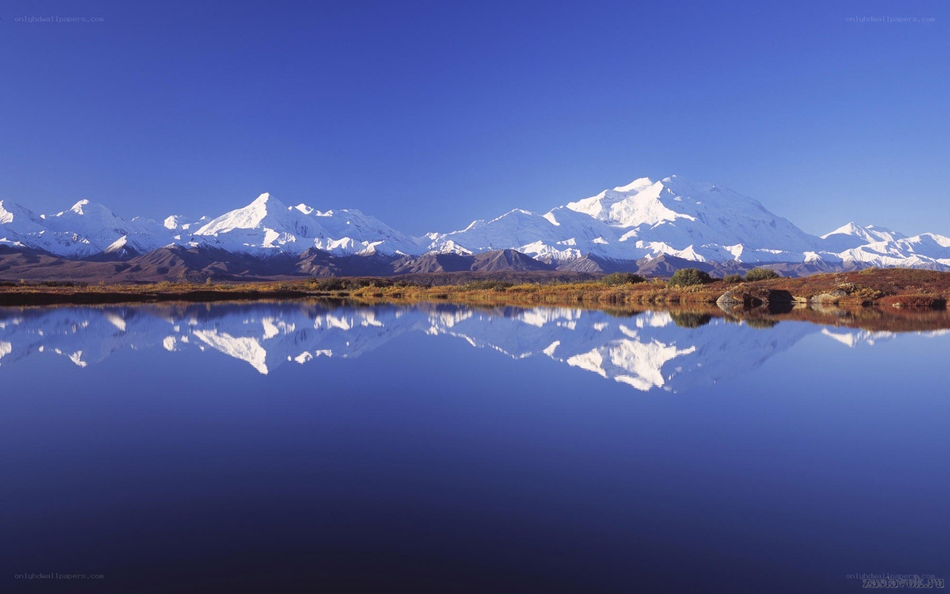 Snow-capped mountains reflected in a lake