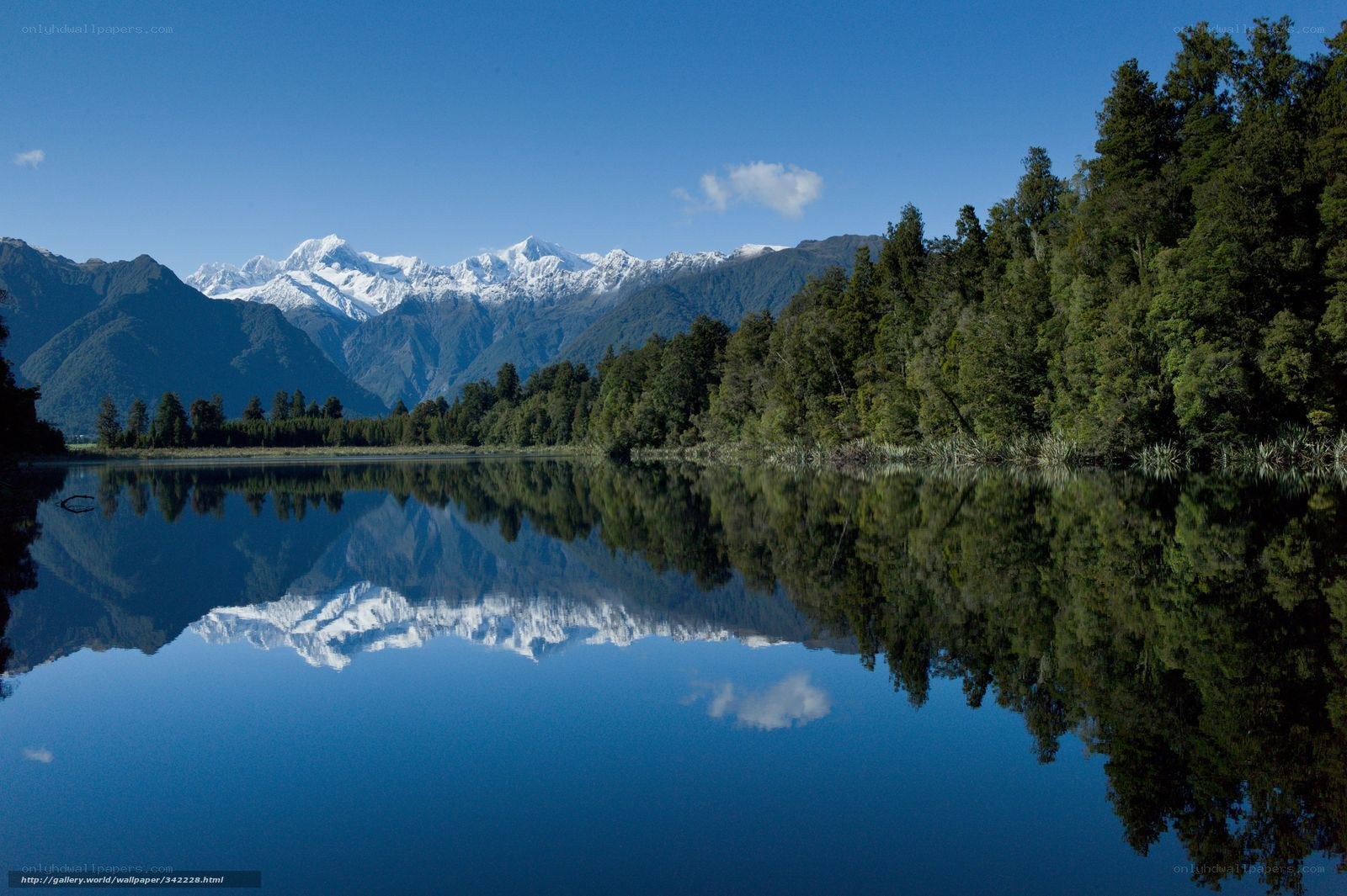 Snow-capped mountains reflected in a lake