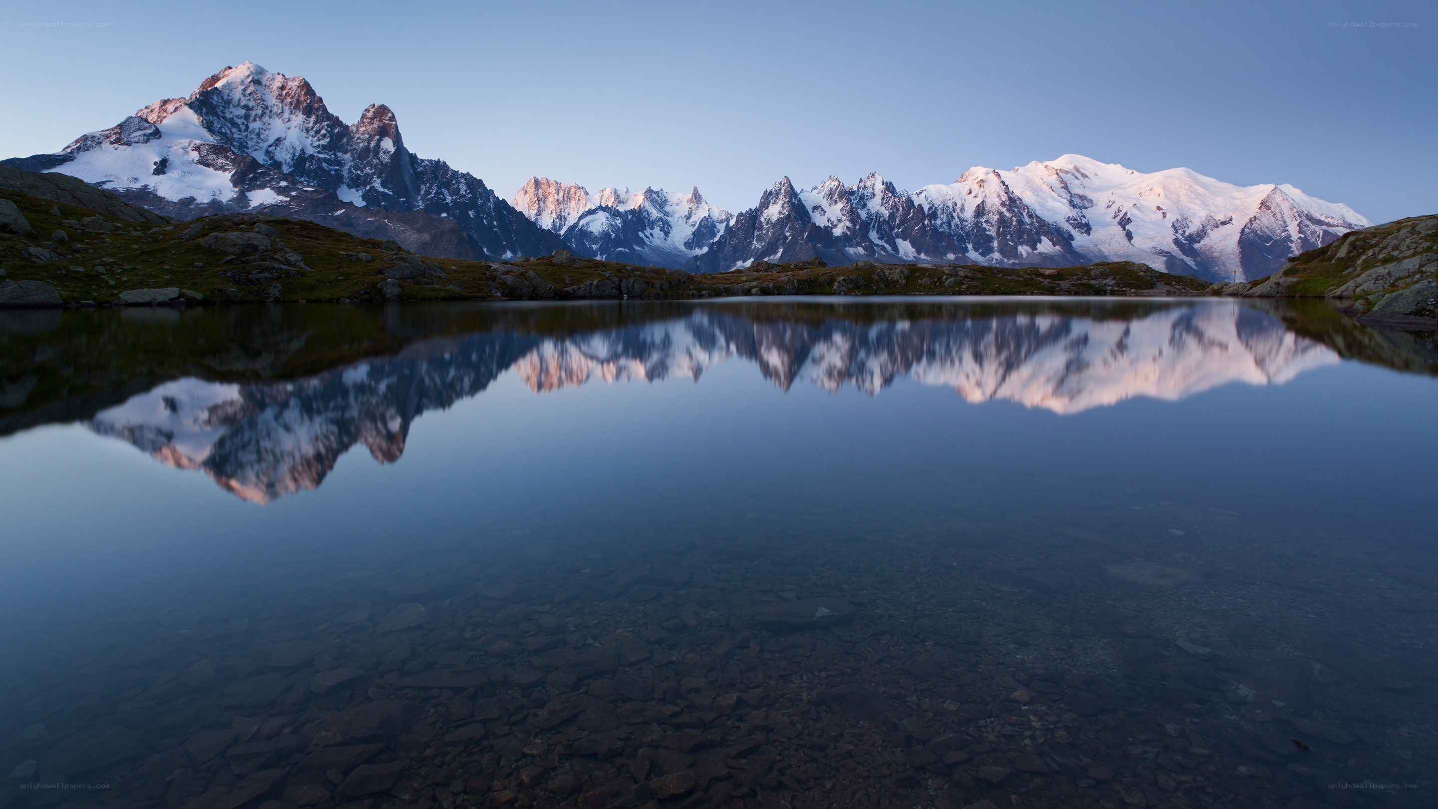 Snow-capped mountains reflected in a lake