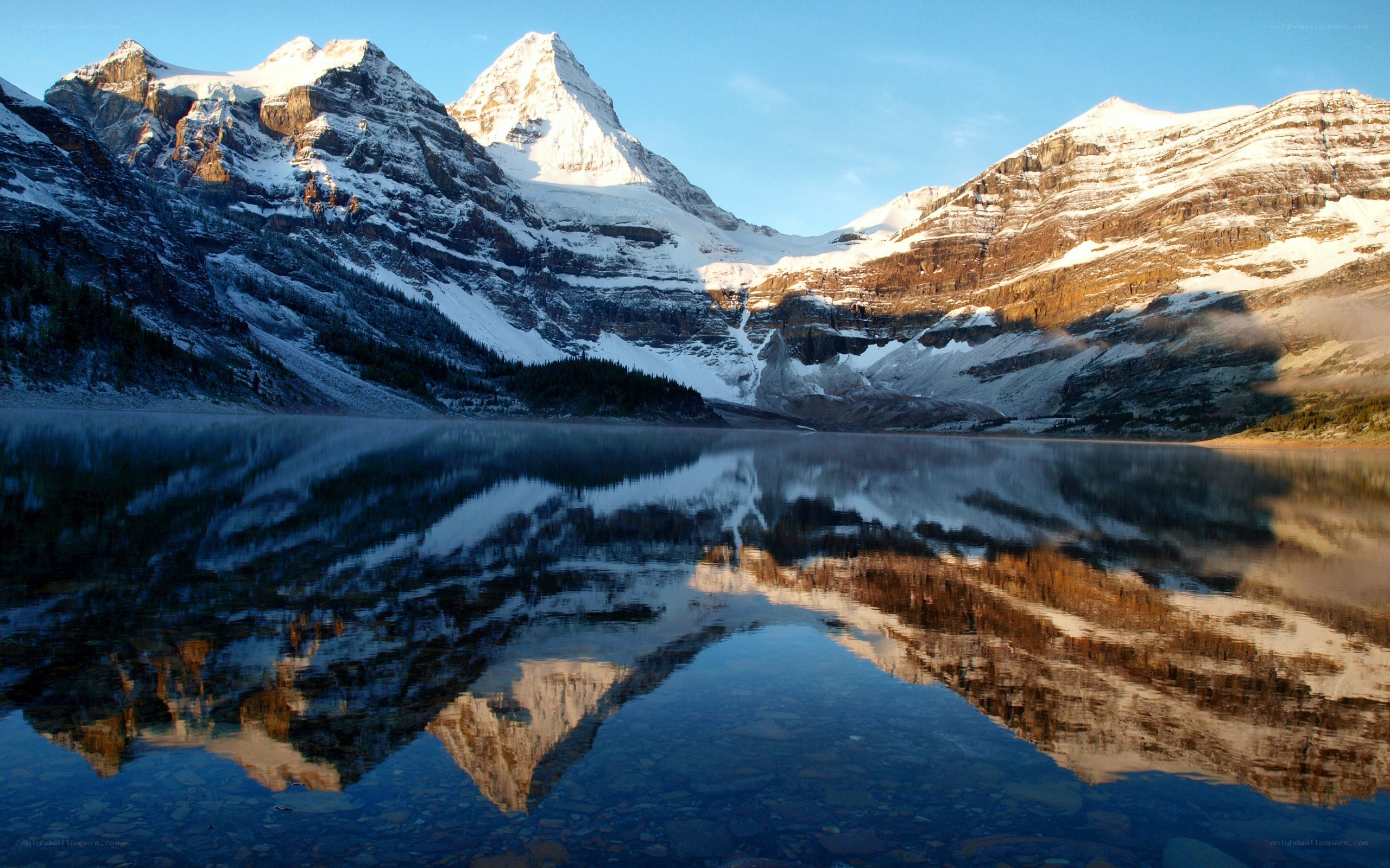 Snow-capped mountains reflected in a lake