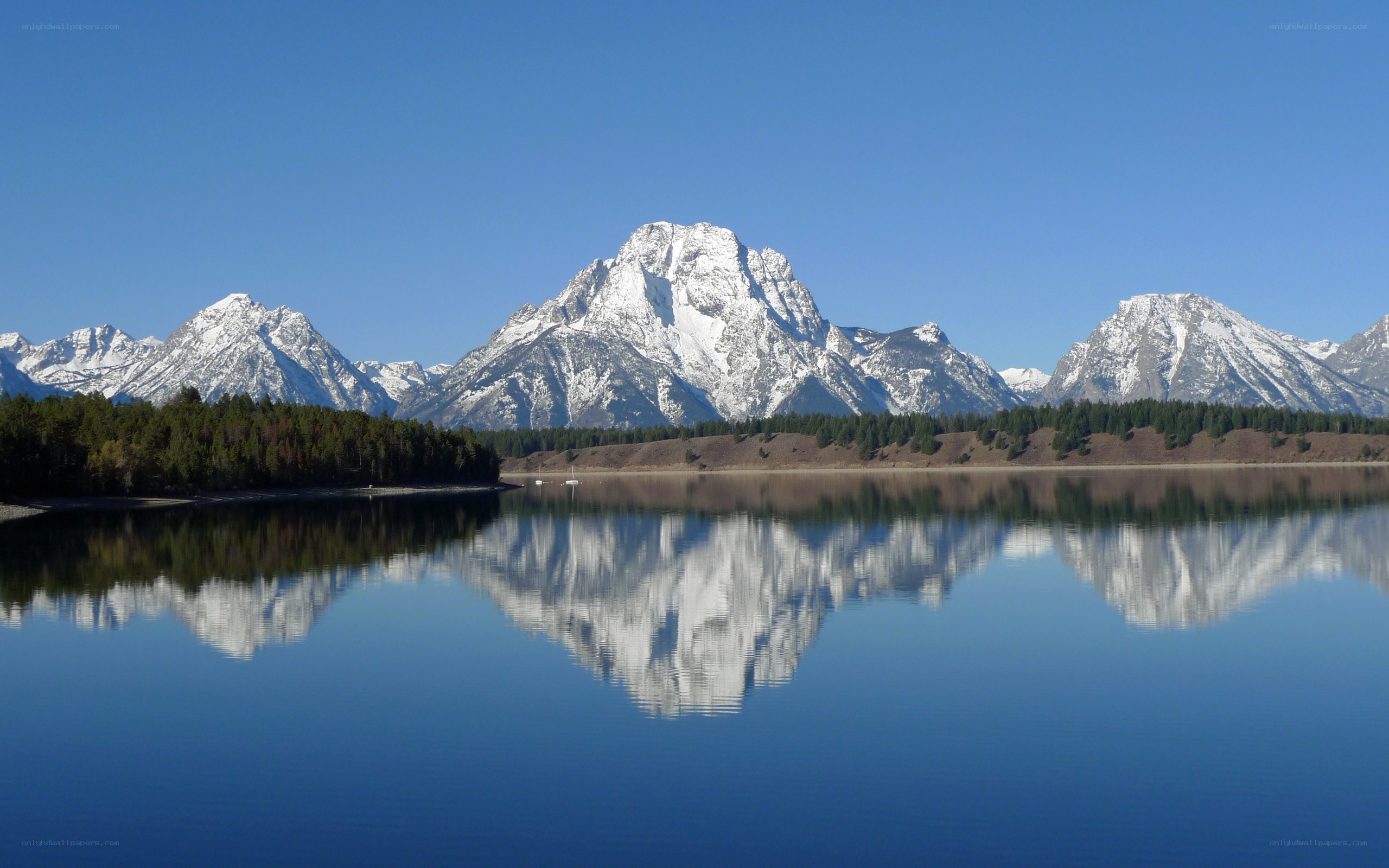 Snow-capped mountains reflected in a lake