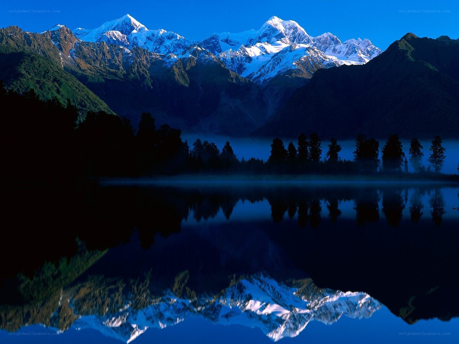 Snow-capped mountains reflected in a lake