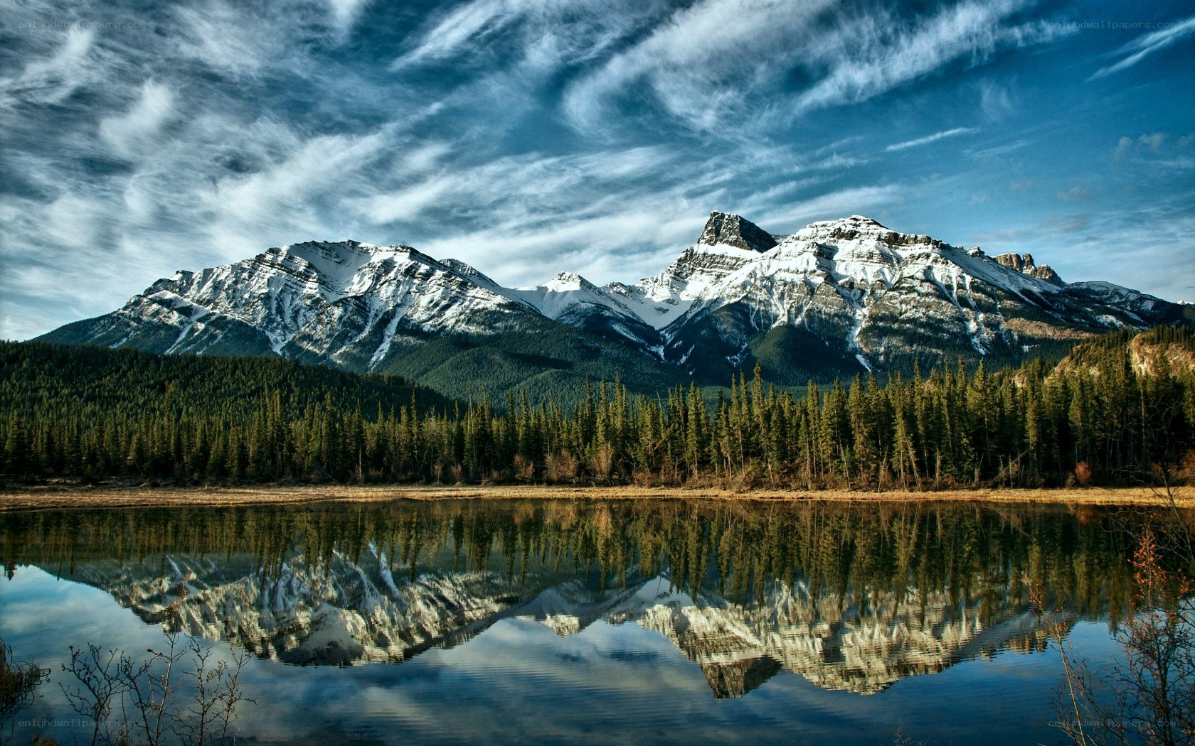Snow-capped mountains reflected in a lake