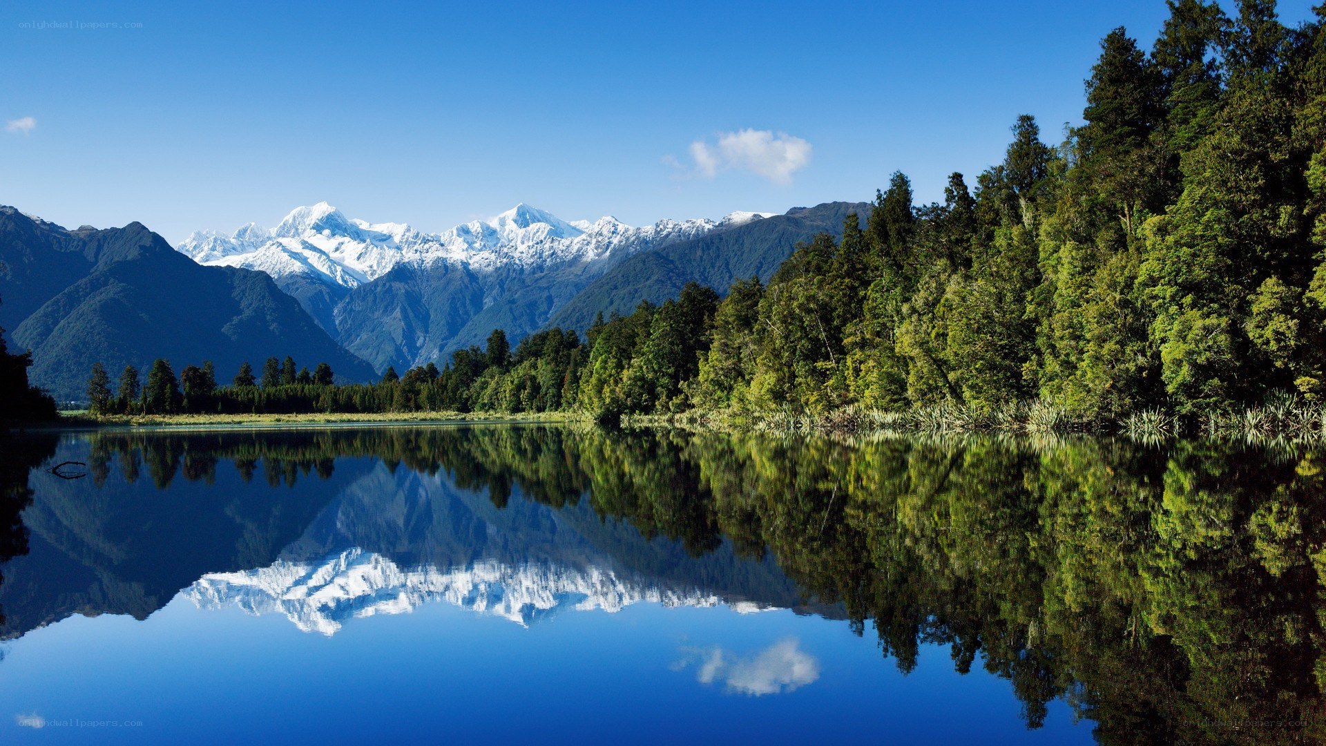 Snow-capped mountains reflected in a lake