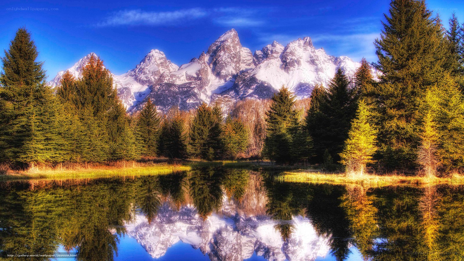 Snow-capped mountains reflected in a lake