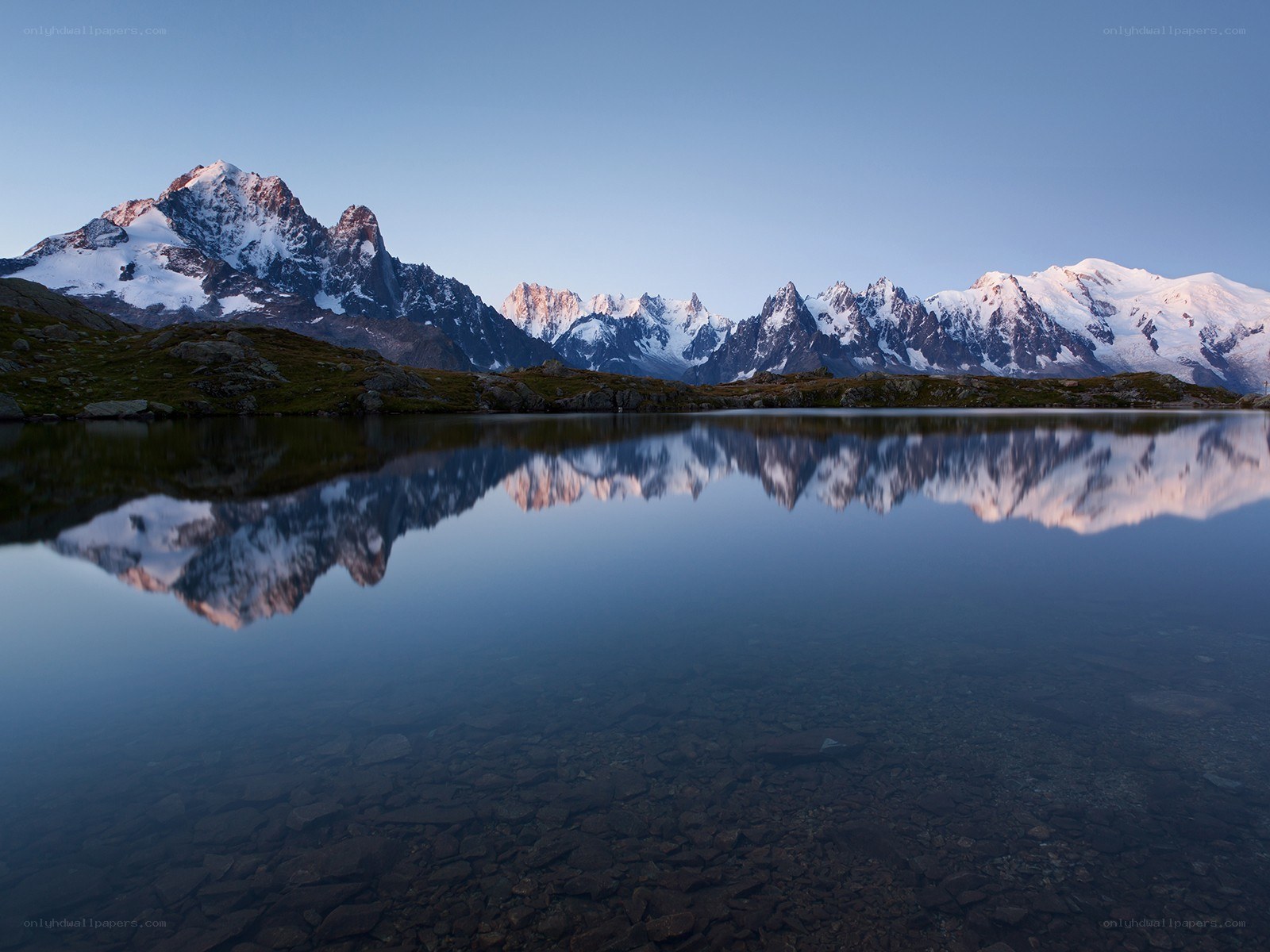 Snow-capped mountains reflected in a lake