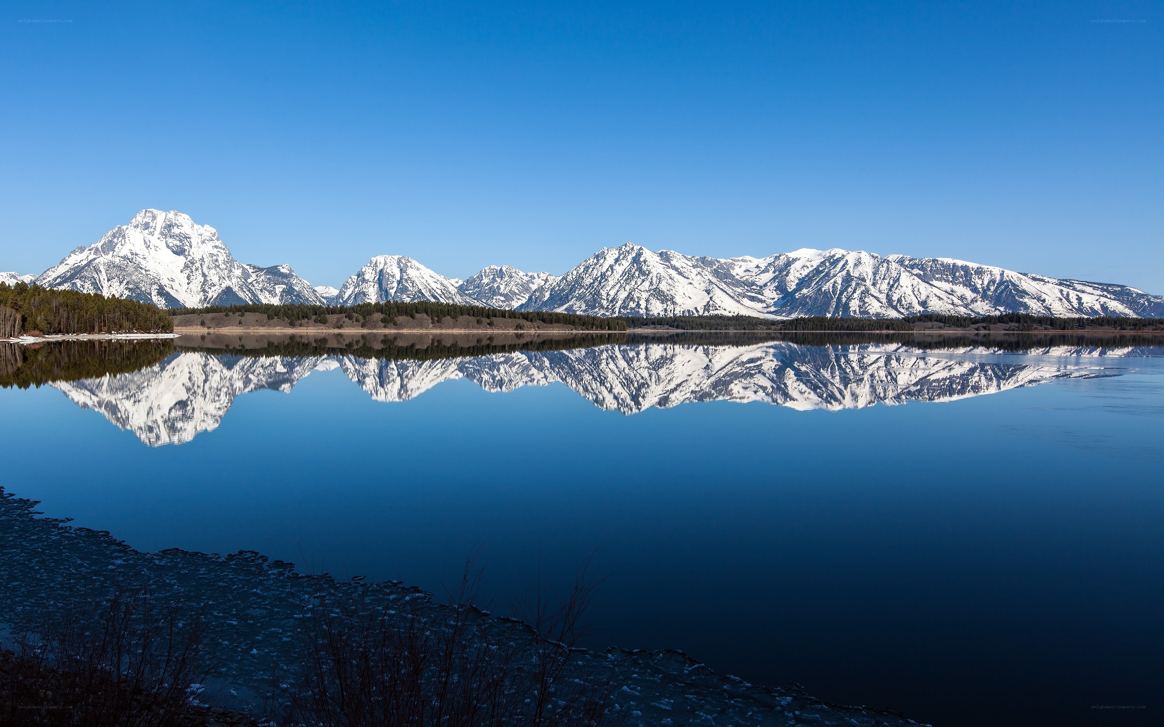 Snow-capped mountains reflected in a lake