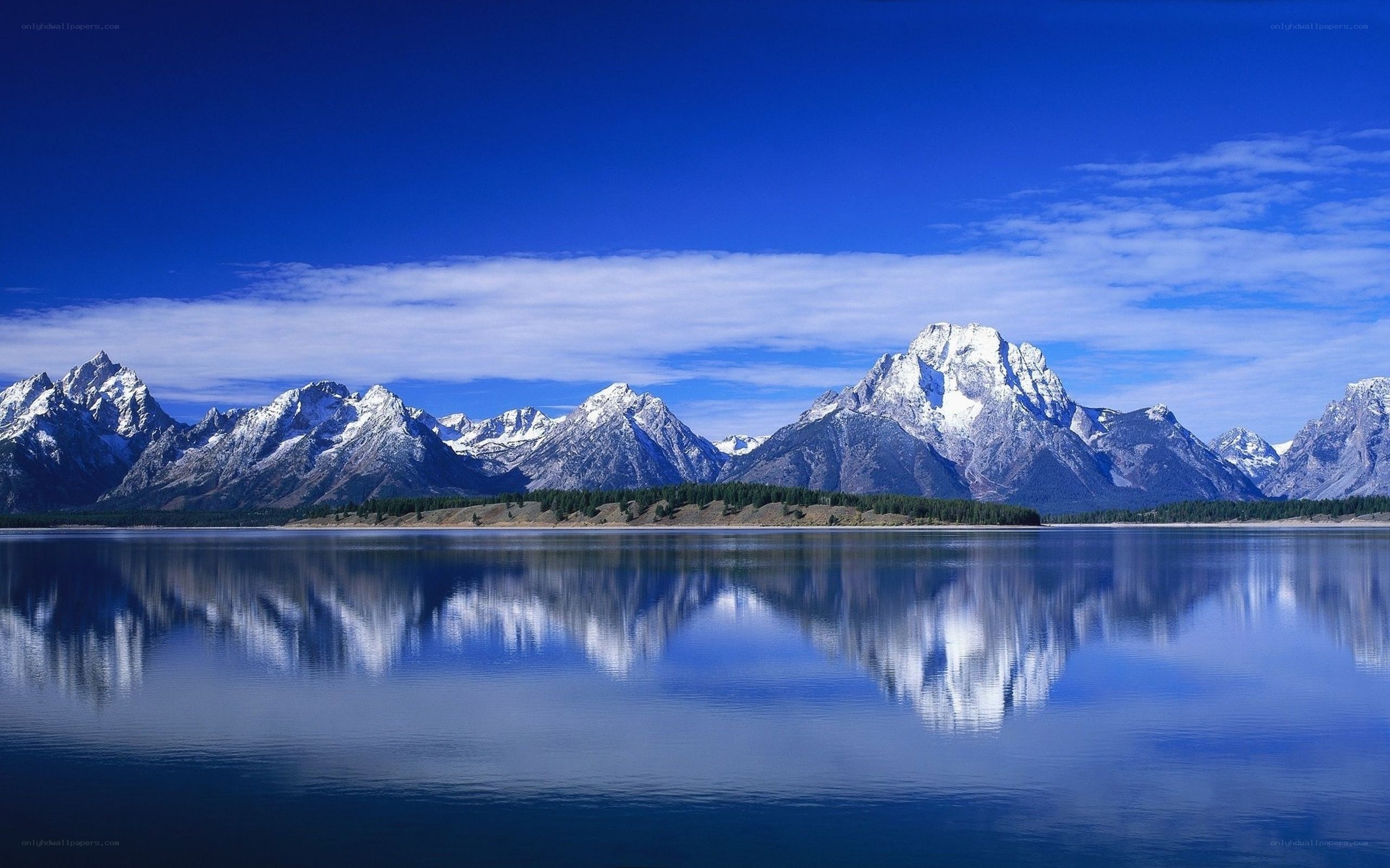 Snow-capped mountains reflected in a lake