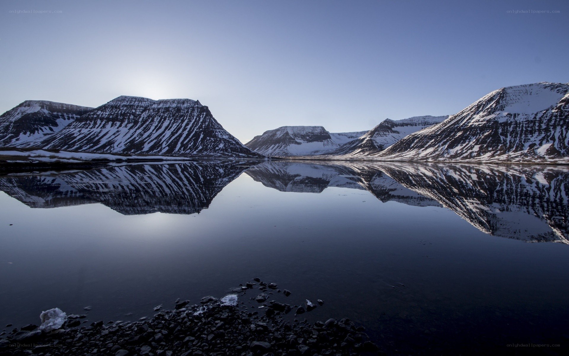 Snow-capped mountains reflected in a lake