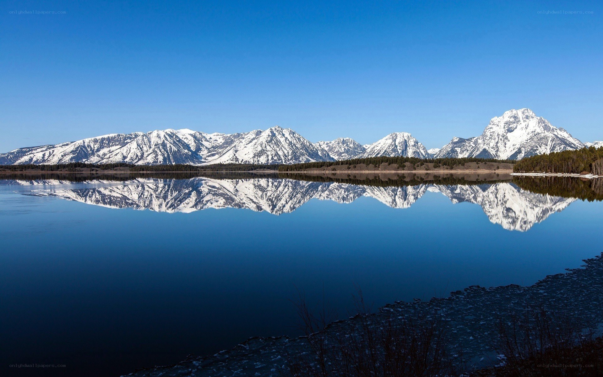 Snow-capped mountains reflected in a lake