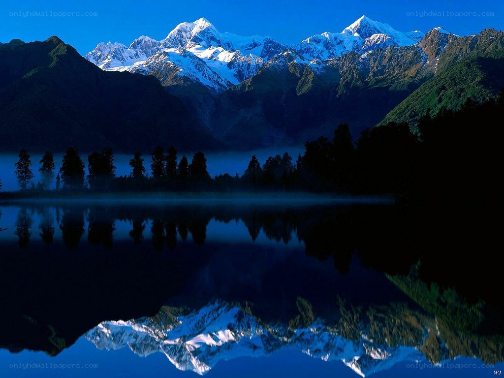 Snow-capped mountains reflected in a lake