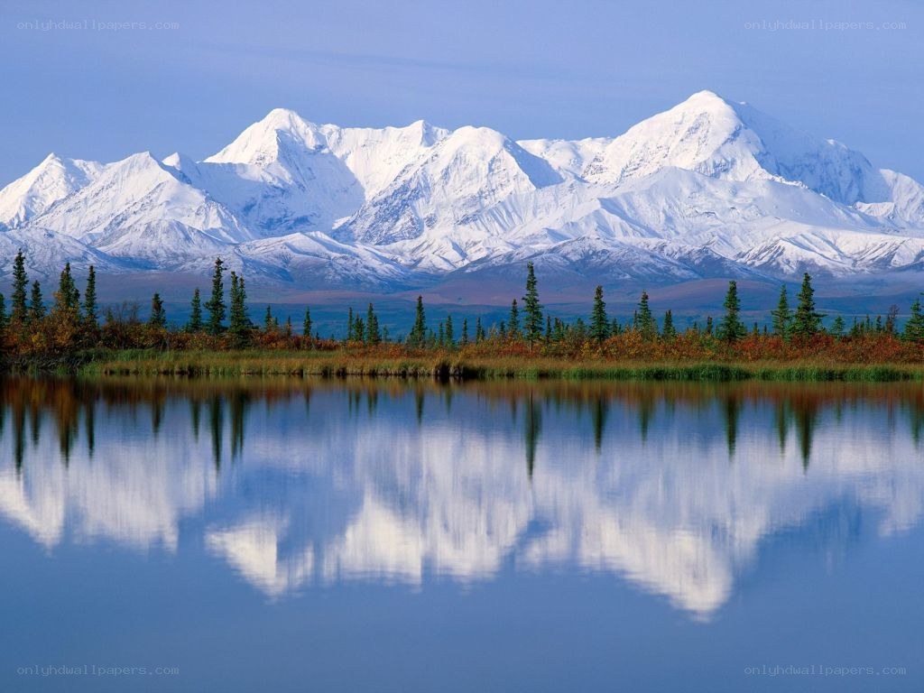 Snow-capped mountains reflected in a lake