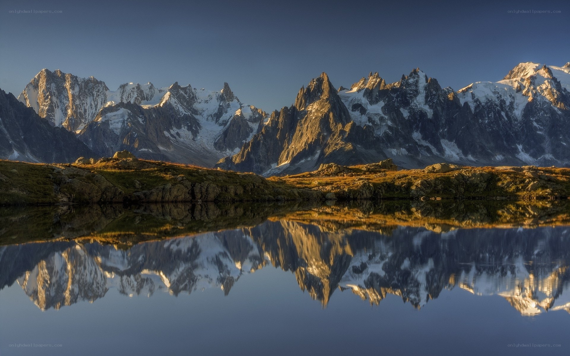 Snow-capped mountains reflected in a lake