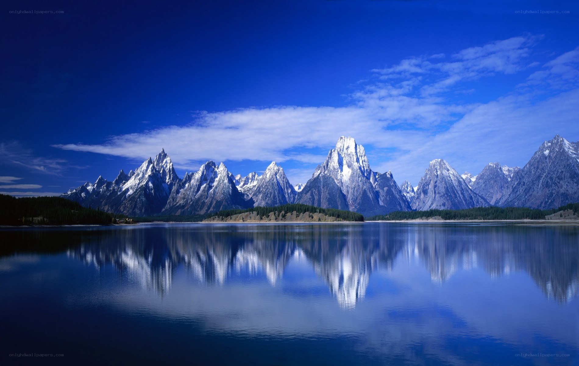Snow-capped mountains reflected in a lake