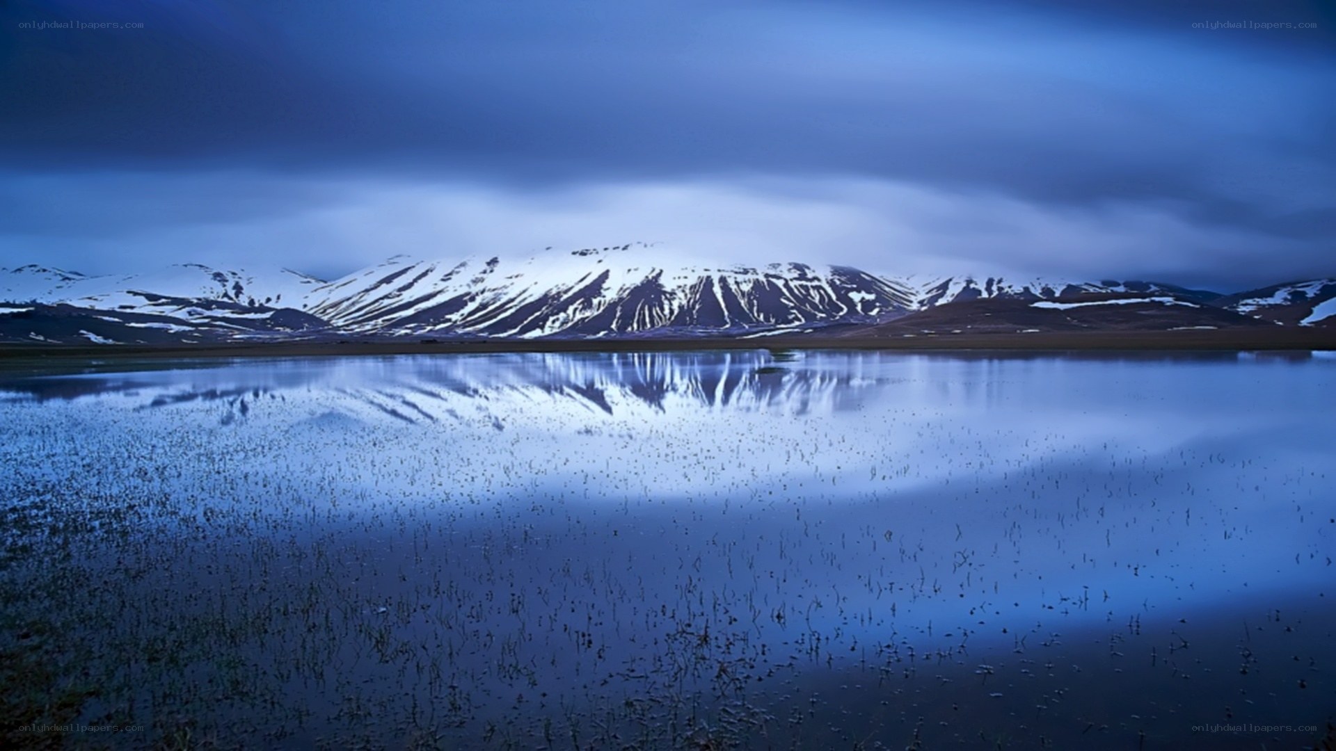 Snow-capped mountains reflected in a lake