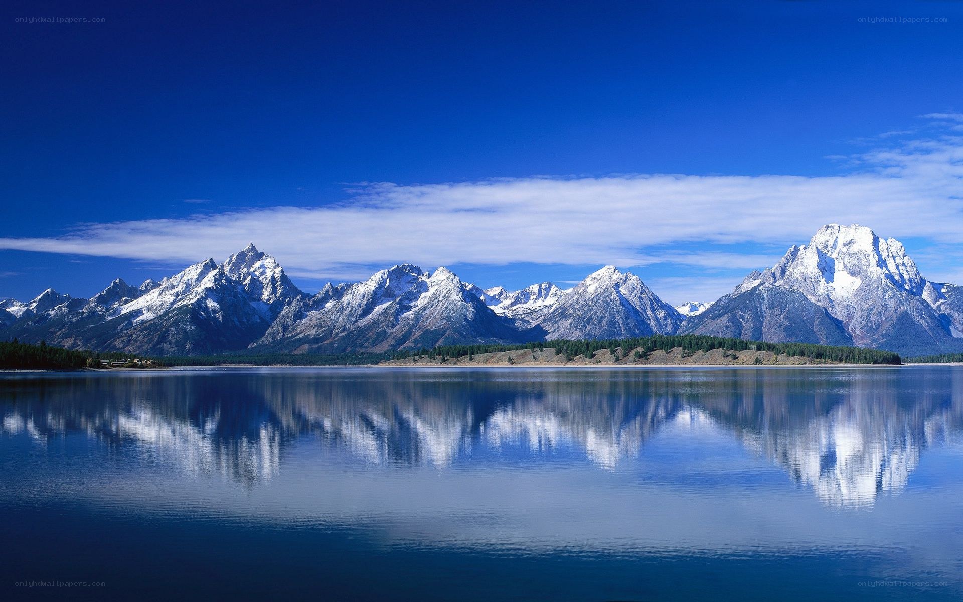 Snow-capped mountains reflected in a lake
