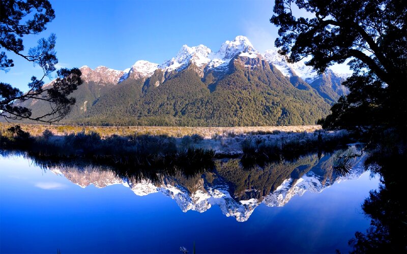 Snow-capped mountains reflected in a lake