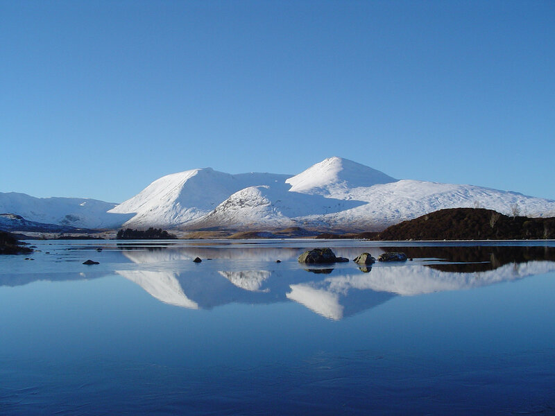Snow-capped mountains reflected in a lake