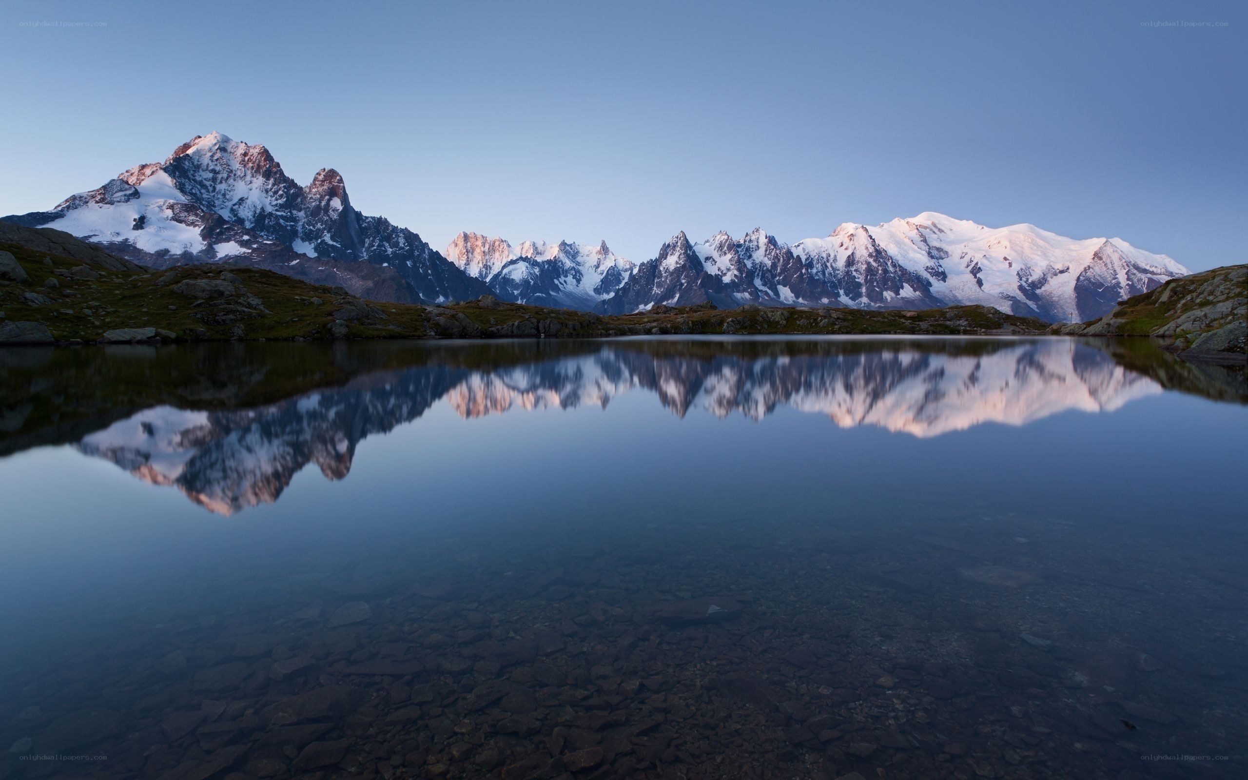 Snow-capped mountains reflected in a lake