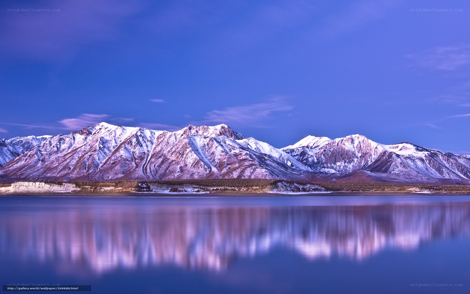 Snow-capped mountains reflected in lake